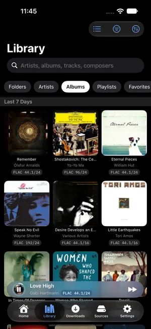 1-bit library — a grid of album artwork with format badges under a row of section chips: Folders, Artists, Albums, Playlists, Favorites