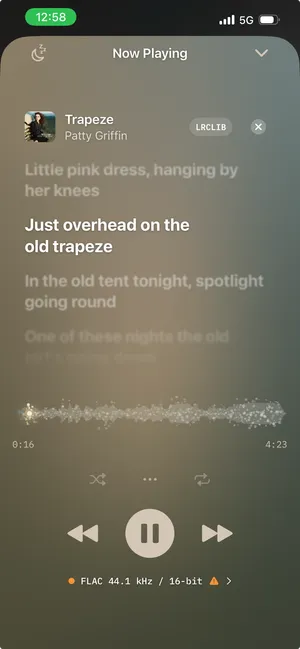 1-bit's lyric sheet on Now Playing — Trapeze by Patty Griffin, the current line bold and the others fading above and below it, with the waveform timeline and transport underneath